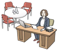 Person sitzt an einem Schreibtisch