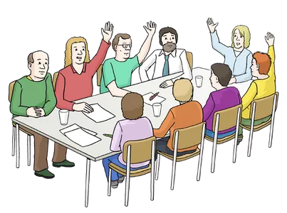 Menschen sitzen an einem Tisch und stimmen per Handzeichen ab